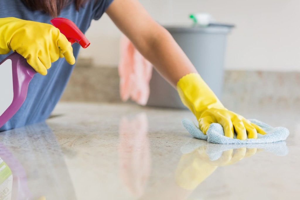 Professional disinfectant cleaning in Austin — eco-friendly sprayer & microfiber wipe sanitizing kitchen countertop for homes and apartments.