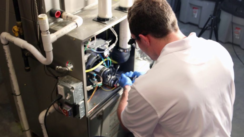 HVAC technician performing professional furnace cleaning and maintenance service on heating system equipment in Austin, Texas